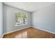 Bedroom featuring neutral walls and hardwood floors, with an external view at 3604 Rivermist Dr, Raleigh, NC 27610