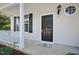 Covered porch and entryway featuring a black front door, white trim and accents, and a small porch mat at 3604 Rivermist Dr, Raleigh, NC 27610