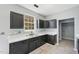 Well-lit kitchen featuring stylish dark cabinetry, white countertops, and tile flooring at 3604 Rivermist Dr, Raleigh, NC 27610