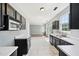 Bright kitchen featuring marble flooring, black cabinets, and modern appliances at 3604 Rivermist Dr, Raleigh, NC 27610