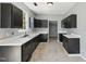 Well-lit kitchen featuring stylish dark cabinetry, white countertops, and tile flooring at 3604 Rivermist Dr, Raleigh, NC 27610