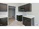 Modern kitchen featuring stylish cabinetry, white countertops, stainless steel microwave, and tile flooring at 3604 Rivermist Dr, Raleigh, NC 27610