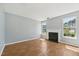 Bright living room boasts hardwood floors, fresh paint, modern fireplace, and large windows for natural light at 3604 Rivermist Dr, Raleigh, NC 27610