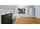 Open concept living room with hardwood floors, fireplace, and adjoining kitchen featuring stainless steel appliances at 3604 Rivermist Dr, Raleigh, NC 27610