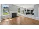 Open concept living room with hardwood floors, fireplace, and adjoining kitchen featuring stainless steel appliances at 3604 Rivermist Dr, Raleigh, NC 27610