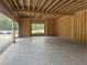 Unfinished three car garage with a concrete floor, framed walls, and view of the outside at 3608 Cobbler Vw Way, Fuquay Varina, NC 27526
