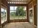 Framed sunroom with large windows that look out on a tranquil scene at 3608 Cobbler Vw Way, Fuquay Varina, NC 27526