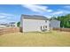 Expansive backyard with a patio, swing set, and wooden fence, providing a private outdoor space at 390 Hunting Wood Dr, Angier, NC 27501