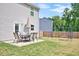 Lush backyard featuring a patio set with an umbrella and a swing set, perfect for outdoor enjoyment at 390 Hunting Wood Dr, Angier, NC 27501