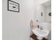 Powder room featuring a pedestal sink, framed novelty art, and neutral decor at 390 Hunting Wood Dr, Angier, NC 27501