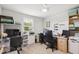 Functional bedroom with bright light, ceiling fan, shelving, and two workstations for your convenience at 390 Hunting Wood Dr, Angier, NC 27501