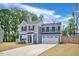 Charming two-story home featuring a two-car garage, manicured lawn, and classic architectural details at 390 Hunting Wood Dr, Angier, NC 27501