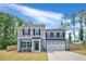 Beautiful two-story home with a well-maintained lawn, showcasing its inviting curb appeal at 390 Hunting Wood Dr, Angier, NC 27501
