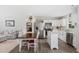 Open floor plan with a view of the kitchen island, dining area, and living room with neutral decor at 390 Hunting Wood Dr, Angier, NC 27501