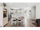 Bright kitchen with white cabinets, stainless steel appliances, and a dining area at 390 Hunting Wood Dr, Angier, NC 27501