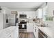 Modern kitchen with white cabinets, stainless steel appliances, and marble countertops at 390 Hunting Wood Dr, Angier, NC 27501
