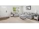 Inviting living room featuring a plush sofa, armchair, ottoman, and ample natural light at 390 Hunting Wood Dr, Angier, NC 27501