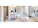 Bright bathroom featuring a soaking tub, double vanity with white cabinets, and a separate shower at 395 Carolina Landing Dr, Zebulon, NC 27597