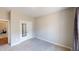 Neutral-toned bedroom with a carpeted floor, mirrored closet and an open doorway at 395 Carolina Landing Dr, Zebulon, NC 27597