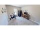 Bedroom with gym equipment, including stationary bike, window, tv and storage shelves at 395 Carolina Landing Dr, Zebulon, NC 27597