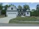 Charming two-story home featuring a welcoming front porch and attached two-car garage at 395 Carolina Landing Dr, Zebulon, NC 27597