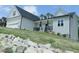 Exterior angle showing the siding detail, front porch, stone accents, and landscaping at 395 Carolina Landing Dr, Zebulon, NC 27597