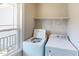 Functional laundry room featuring a washer, dryer, window, and an overhead shelf at 395 Carolina Landing Dr, Zebulon, NC 27597