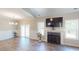 Spacious living room offering access to the patio with fireplace and large windows at 395 Carolina Landing Dr, Zebulon, NC 27597