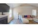 Living room showcasing fireplace, mantel, hardwood floors, and large windows at 395 Carolina Landing Dr, Zebulon, NC 27597