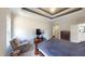 Primary bedroom featuring a tray ceiling and an ensuite bathroom at 395 Carolina Landing Dr, Zebulon, NC 27597