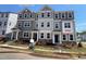 New two-story townhome features a stone facade, neutral siding and professionally landscaped yard at 4004 Silver Oak Ln, Durham, NC 27703