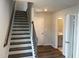 Bright foyer area with hardwood flooring, access to a powder room and the home's staircase at 4004 Silver Oak Ln, Durham, NC 27703