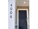 Welcoming home entrance featuring a navy blue front door and the house number '4004' at 4004 Silver Oak Ln, Durham, NC 27703