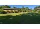 Green, well-manicured backyard with a detached garage and lush surrounding greenery at 4170 Buckhorn Rd, Sanford, NC 27330