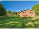 Brick home with a well-kept backyard, detached garage, and picturesque landscaping at 4170 Buckhorn Rd, Sanford, NC 27330