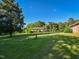 Expansive backyard featuring a detached garage and mature trees, perfect for outdoor activities at 4170 Buckhorn Rd, Sanford, NC 27330