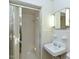 Bright bathroom featuring a shower with glass doors and white tiled walls at 4170 Buckhorn Rd, Sanford, NC 27330