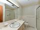 Well-lit bathroom with a vanity, mirror, tiled walls, and a glass-enclosed shower at 4170 Buckhorn Rd, Sanford, NC 27330