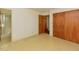 Bedroom showcasing an open doorway, wood closet doors, and a neutral color scheme at 4170 Buckhorn Rd, Sanford, NC 27330