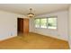Bedroom featuring a large window, carpeted flooring, and a doorway to another room at 4170 Buckhorn Rd, Sanford, NC 27330