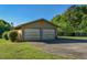 Spacious two-car garage with an adjacent lawn area and wooded backdrop at 4170 Buckhorn Rd, Sanford, NC 27330