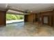 Spacious garage with high ceilings, wood paneled walls, and an open overhead door at 4170 Buckhorn Rd, Sanford, NC 27330