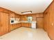 Classic kitchen featuring wooden cabinets, white appliances, and ample counter space at 4170 Buckhorn Rd, Sanford, NC 27330