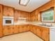 A corner view of the kitchen with wooden cabinets and tile flooring at 4170 Buckhorn Rd, Sanford, NC 27330