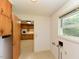 A laundry area with a window and cabinets with an adjoining room at 4170 Buckhorn Rd, Sanford, NC 27330