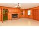 Living room featuring a wood-paneled wall, a classic brick fireplace, and neutral flooring at 4170 Buckhorn Rd, Sanford, NC 27330