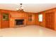 Spacious living room with brick fireplace, wood paneling, and unique light fixture at 4170 Buckhorn Rd, Sanford, NC 27330