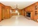 Living room with wood paneling, a brick fireplace, neutral flooring, and classic light fixtures at 4170 Buckhorn Rd, Sanford, NC 27330