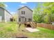 Backyard view showcasing a wooden deck with stairs leading to a concrete patio at 419 E East Hinton St, Clayton, NC 27520