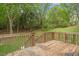 A backyard wooden deck with stairs, overlooking a lush green lawn at 419 E East Hinton St, Clayton, NC 27520